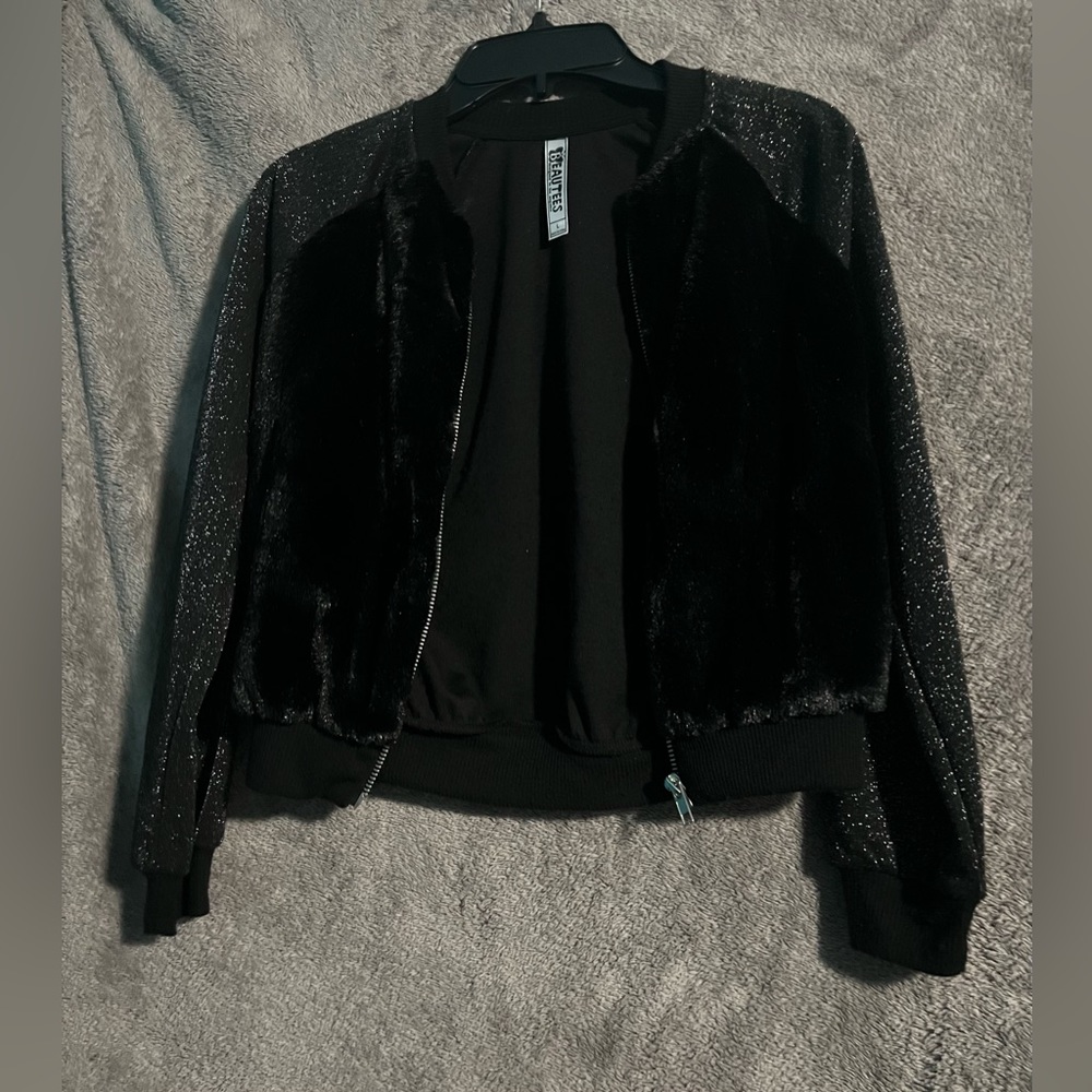 Black Jacket with black fur on the front and silver sparkles .